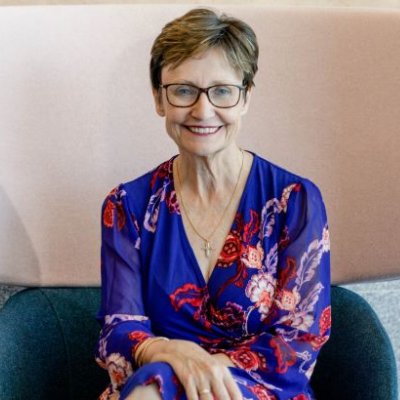 Associate Professor Rhonda Faragher seated in high back chair. Image, UQ